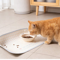 Cat eating on an anti-spill pet food mat with snap-up sides