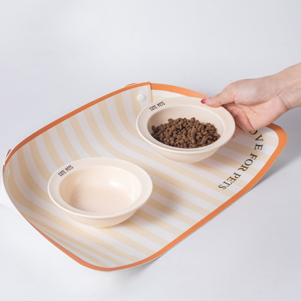 Food and water bowls on a wipeable pet placemat