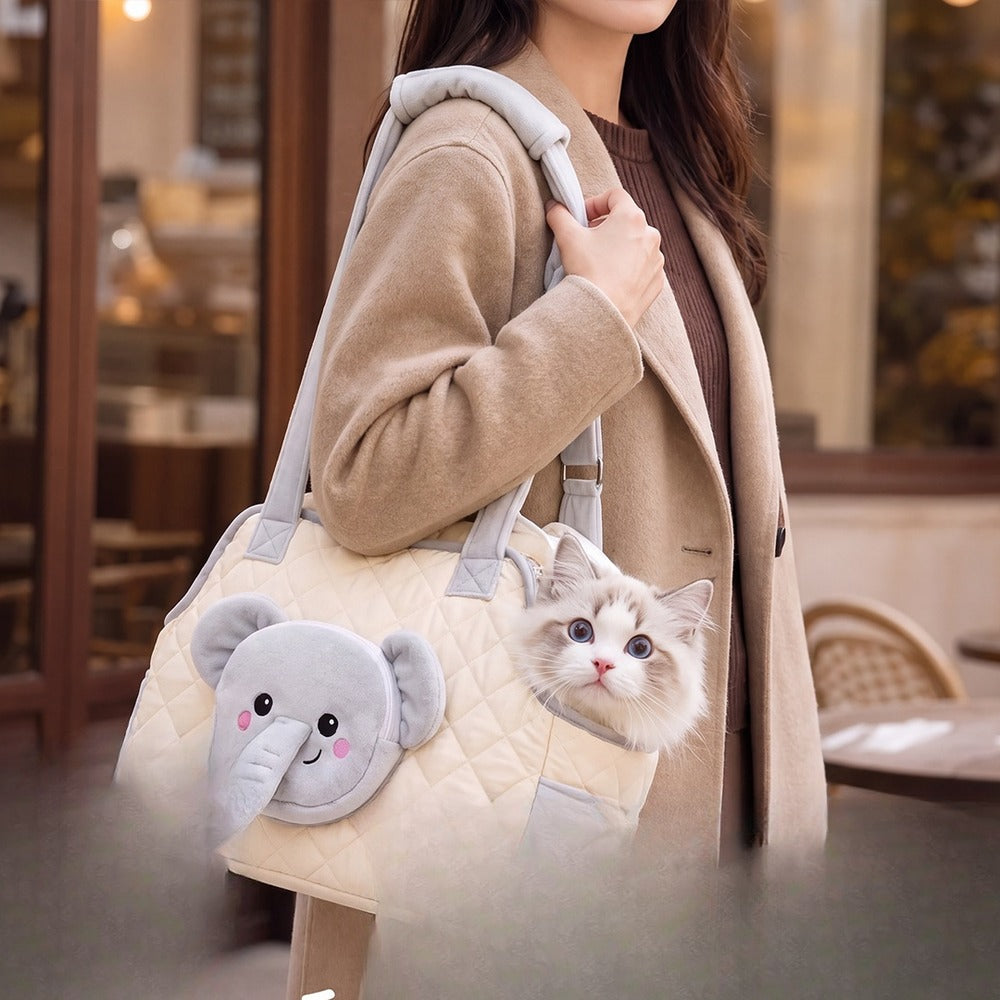 Elephant-face cat carrier tote worn over the shoulder with a cat peeking out