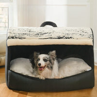Border collie in black covered dog house bed