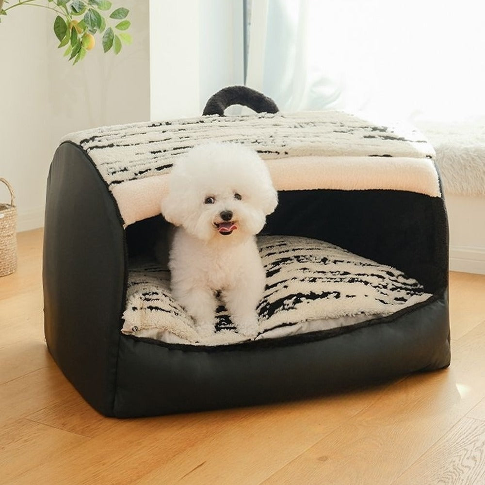 Bichon sitting in black plush pet den