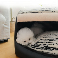 Small dog sleeping inside covered pet bed