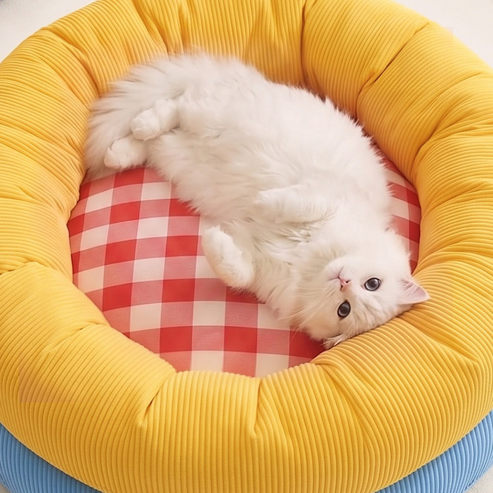 White cat relaxing in plush donut pet bed