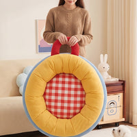 Carrying the donut pet bed by its handle