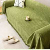 Green chenille couch cover draped over a sofa