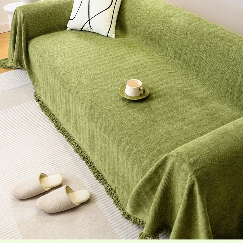 Green chenille couch cover draped over a sofa