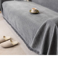 Gray sofa cover draped over a couch