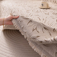 Lifting the cover to show its thick fringed edge