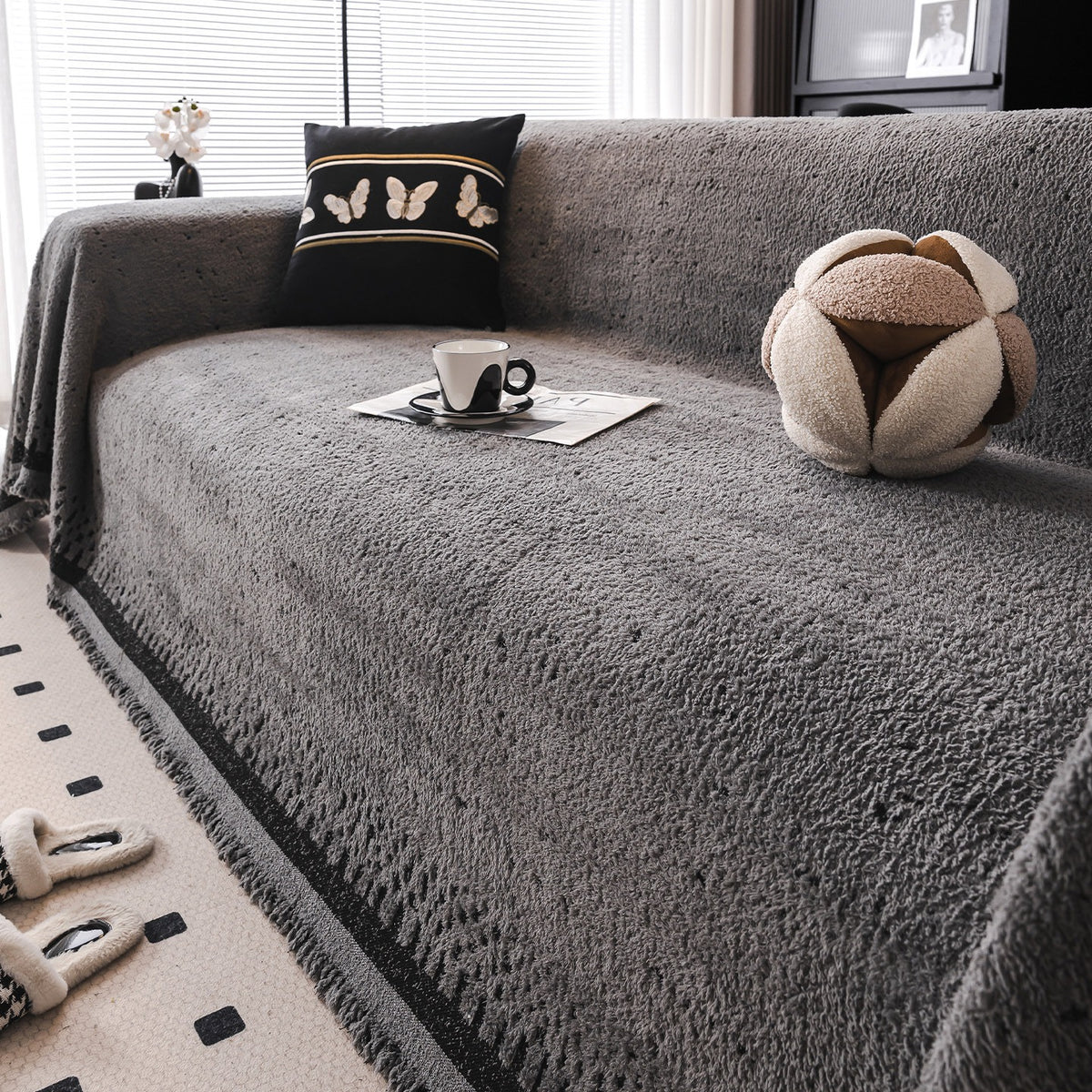 Speckled plush sofa cover in gray and black