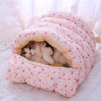 Cat lounging in pink floral burrow bed