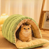 Cat in green plaid burrow bed with open flap
