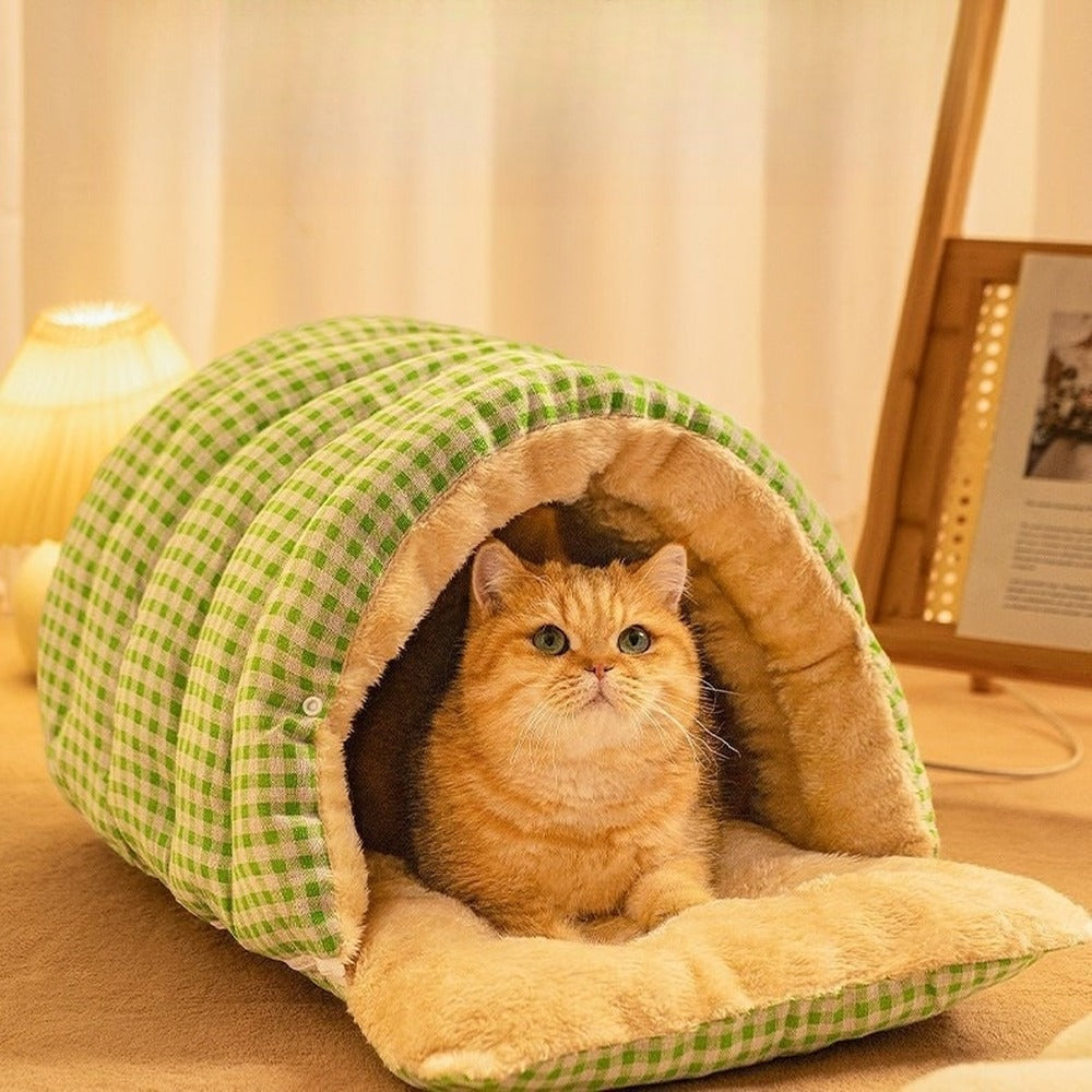 Cat in green plaid burrow bed with open flap