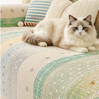 Cat lounging on a striped chenille sofa cover